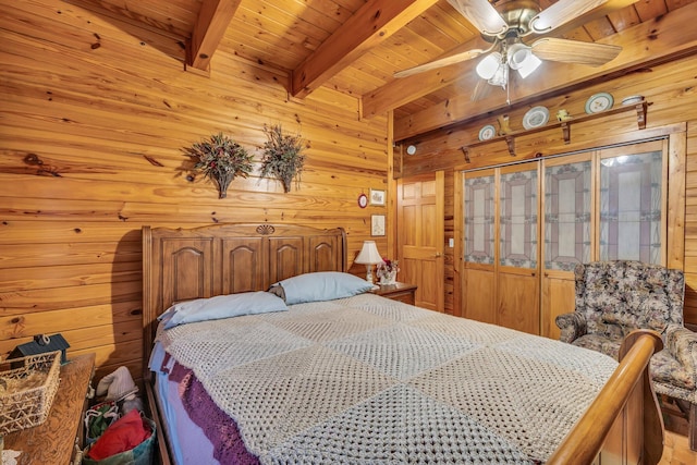 bedroom featuring wooden ceiling, ceiling fan, wood walls, and beamed ceiling