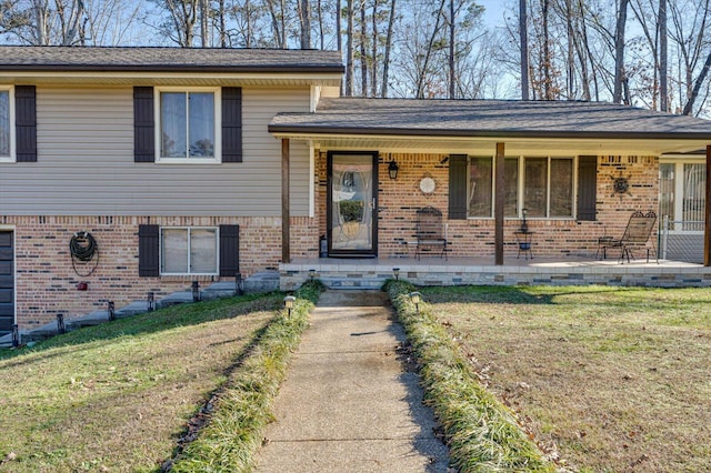 tri-level home featuring a front yard and a porch