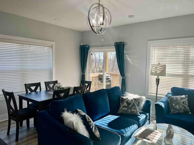 living room featuring wood-type flooring and a chandelier