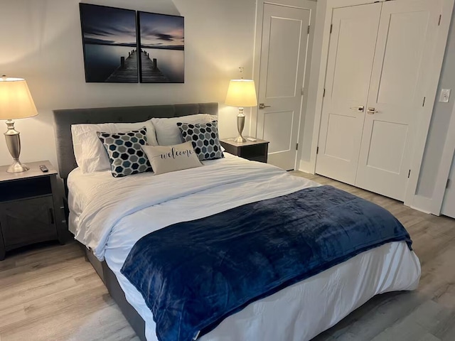 bedroom with a closet and light hardwood / wood-style floors