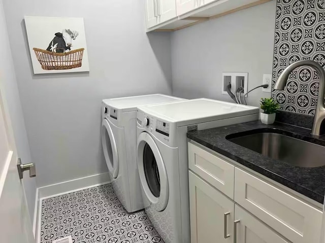 washroom featuring cabinets, washer and clothes dryer, and sink