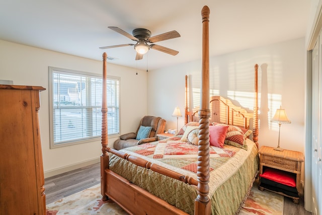 bedroom with ceiling fan and hardwood / wood-style flooring