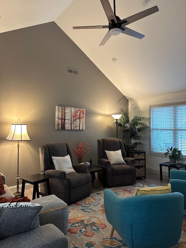 living room featuring ceiling fan and high vaulted ceiling