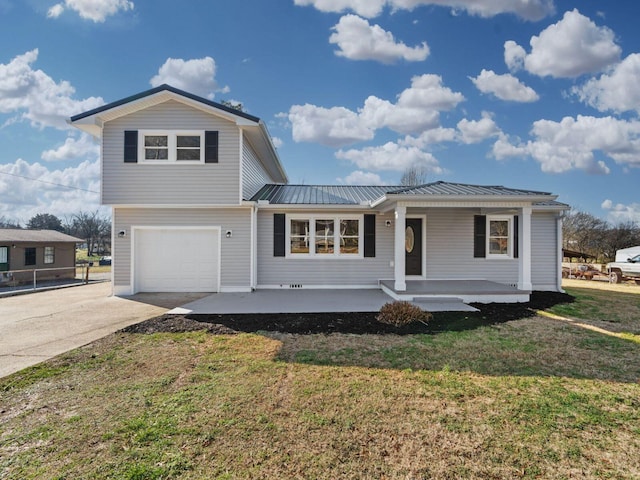 view of front facade featuring a front lawn, a garage, and a porch