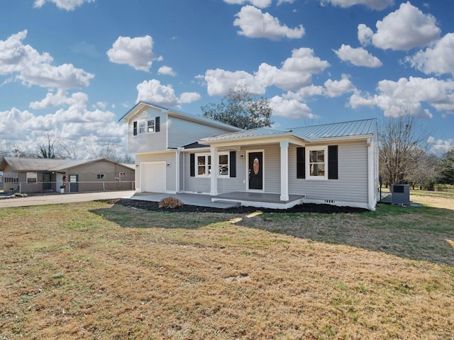 view of front of property featuring a front lawn, covered porch, and a garage