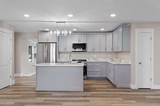 kitchen featuring pendant lighting, appliances with stainless steel finishes, and gray cabinetry