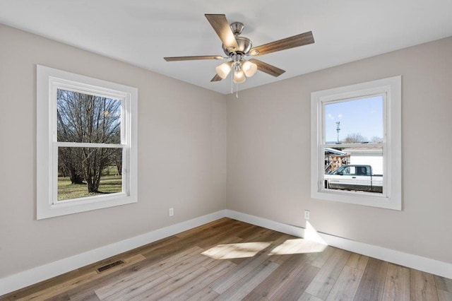 spare room with ceiling fan and hardwood / wood-style flooring