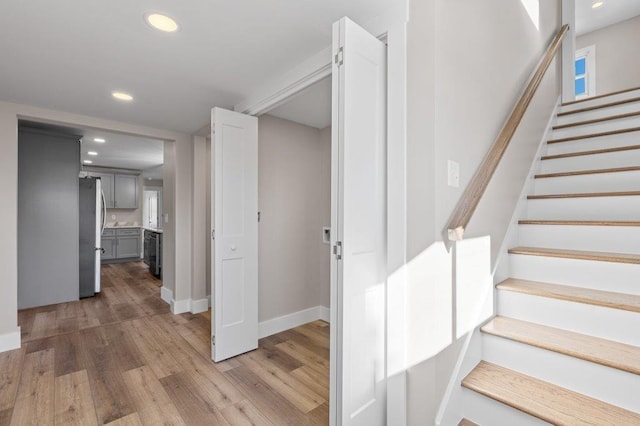 staircase with hardwood / wood-style floors