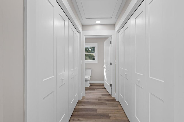 corridor with wood-type flooring