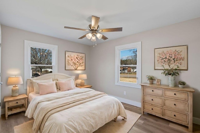 bedroom with ceiling fan and hardwood / wood-style flooring