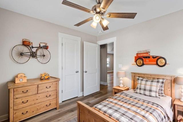 bedroom with ceiling fan and dark hardwood / wood-style floors