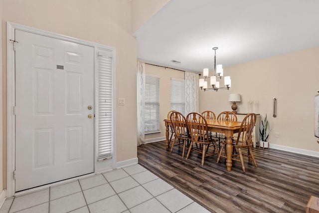 dining area with a notable chandelier and light tile patterned flooring