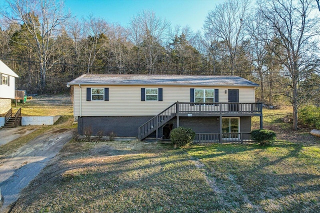 rear view of property with a lawn and a wooden deck