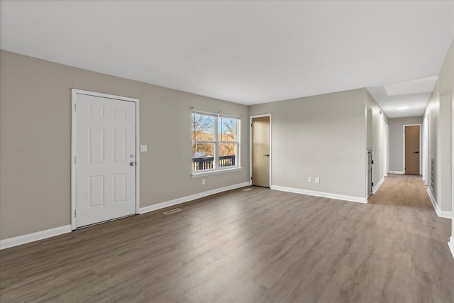 spare room featuring wood-type flooring