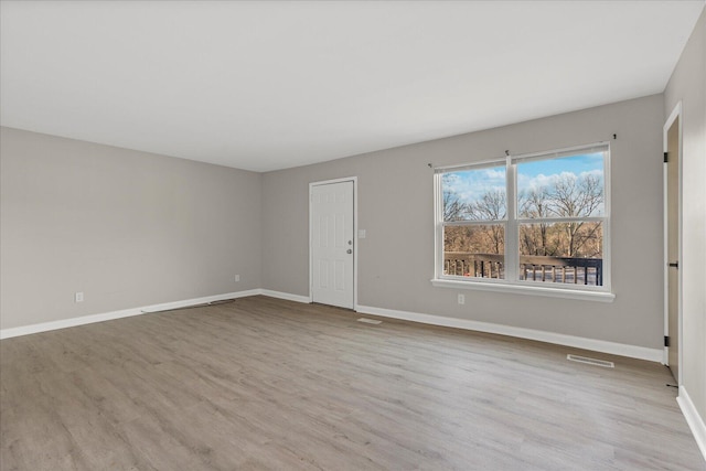 spare room featuring light hardwood / wood-style flooring