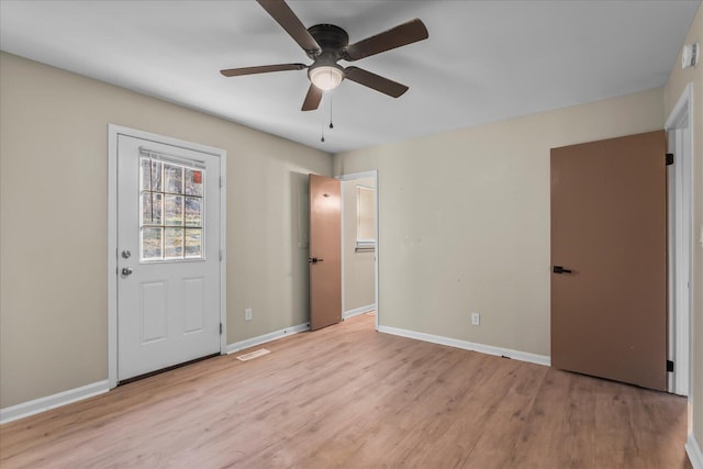 foyer with ceiling fan and light hardwood / wood-style floors