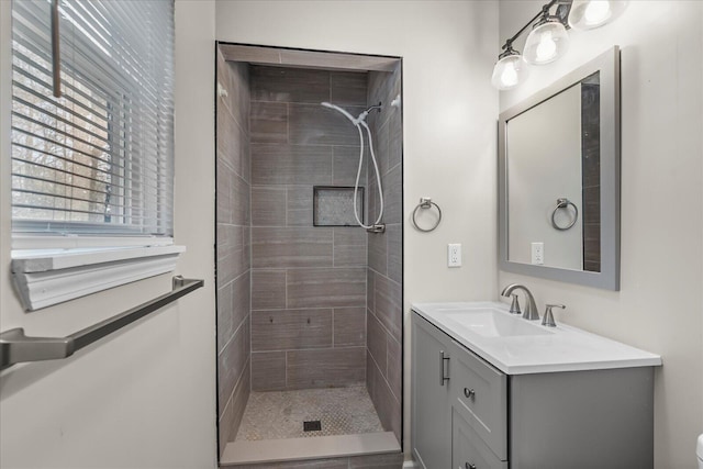 bathroom featuring vanity and a tile shower