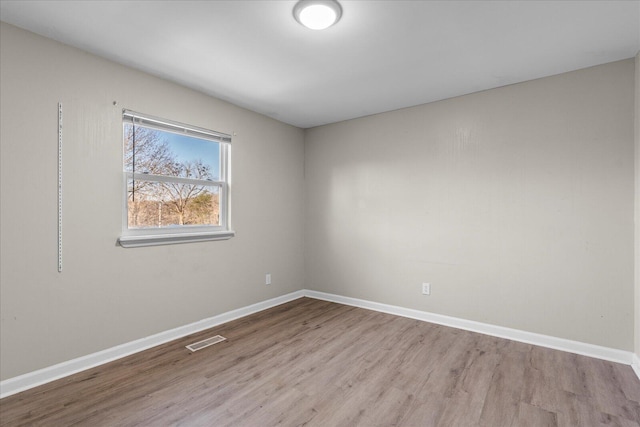 empty room with light hardwood / wood-style floors