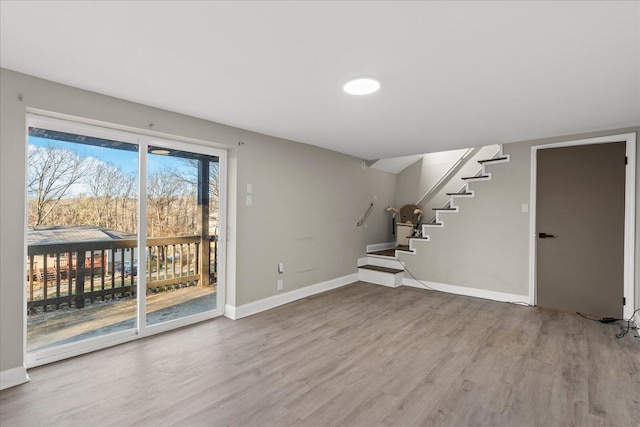 basement with hardwood / wood-style flooring