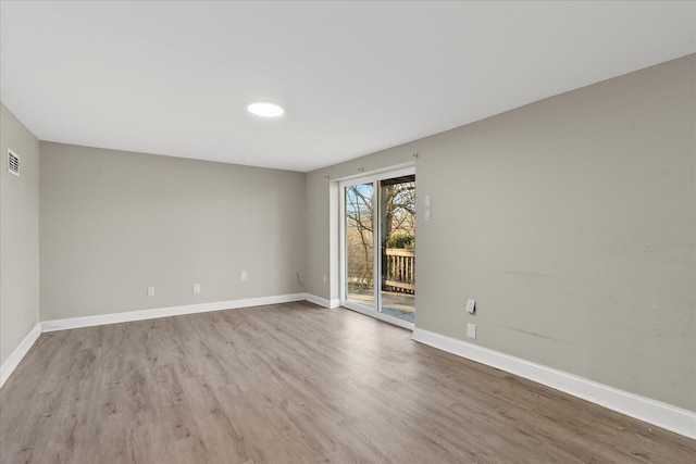 empty room with hardwood / wood-style floors