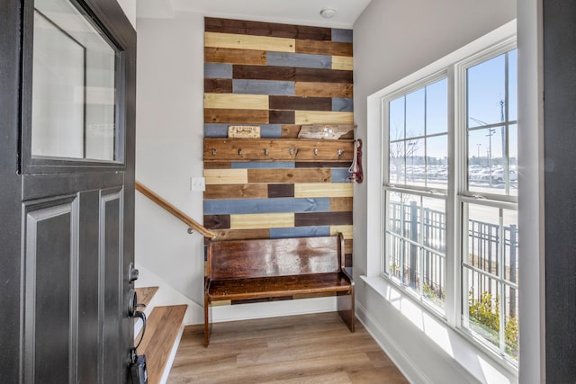 interior space with hardwood / wood-style flooring and wood walls