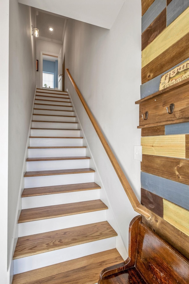 stairway featuring ornamental molding