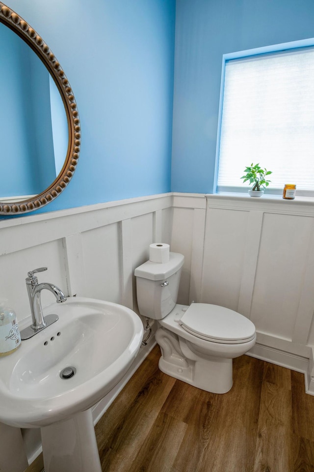 bathroom with toilet, hardwood / wood-style flooring, and sink