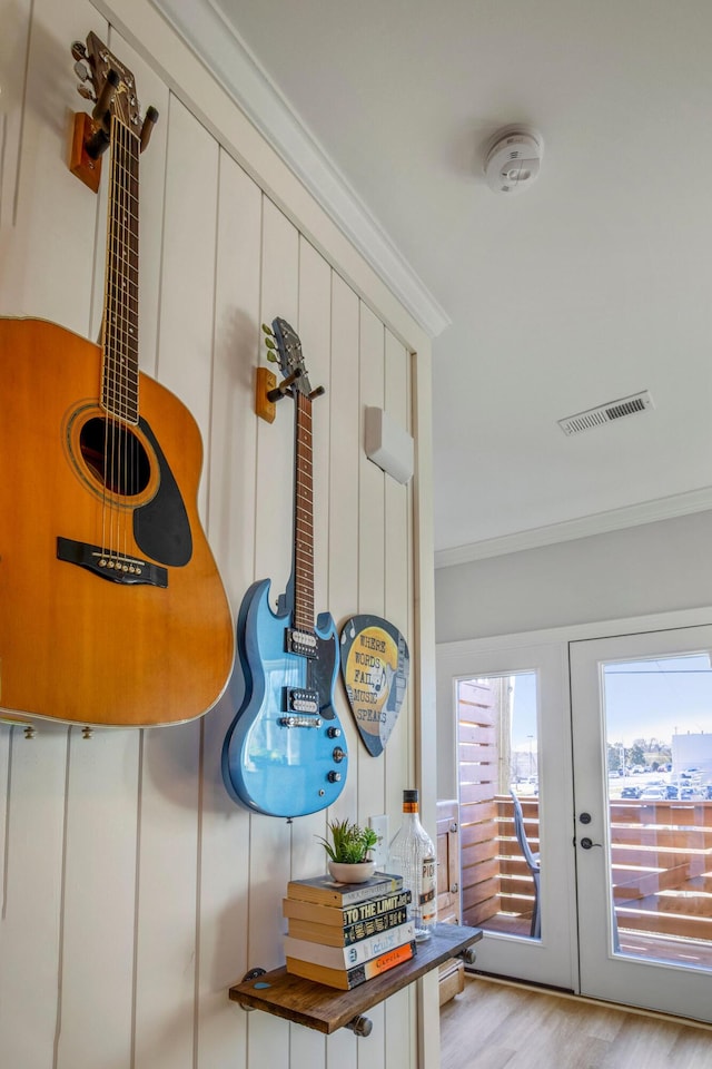 mudroom featuring french doors, crown molding, and light hardwood / wood-style flooring