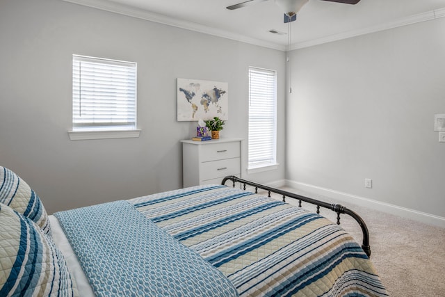 carpeted bedroom featuring ceiling fan, ornamental molding, and multiple windows