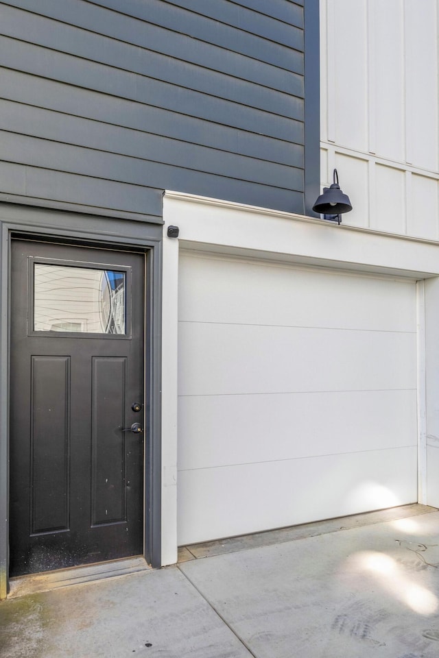 doorway to property with a garage