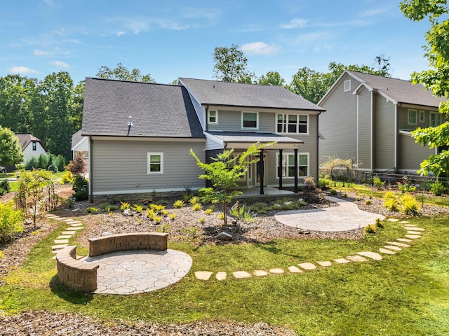 rear view of property with a lawn and a patio area