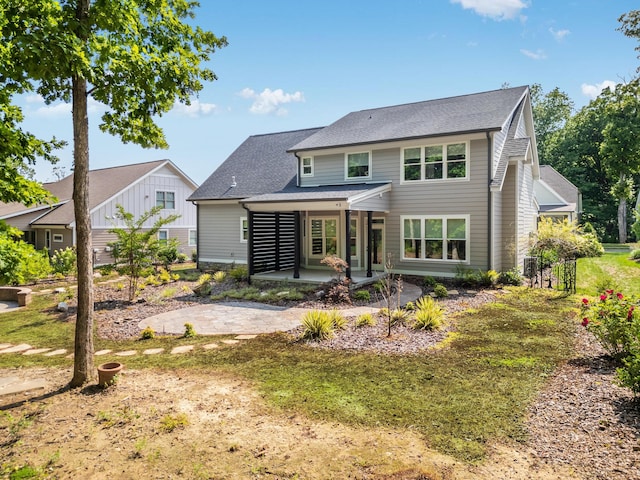 rear view of property with a lawn and a patio area