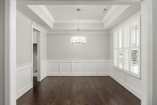 unfurnished dining area featuring crown molding, dark wood-type flooring, and a tray ceiling