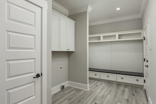 laundry area with cabinets, light hardwood / wood-style flooring, ornamental molding, and hookup for an electric dryer