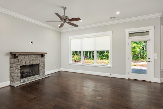 unfurnished living room with dark wood-type flooring, ceiling fan, ornamental molding, and a stone fireplace