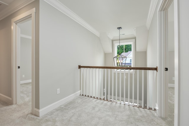 hall with light colored carpet, vaulted ceiling, and crown molding