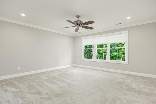 spare room featuring light carpet and crown molding