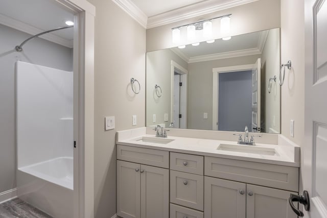 bathroom featuring bathtub / shower combination, vanity, ornamental molding, and hardwood / wood-style floors