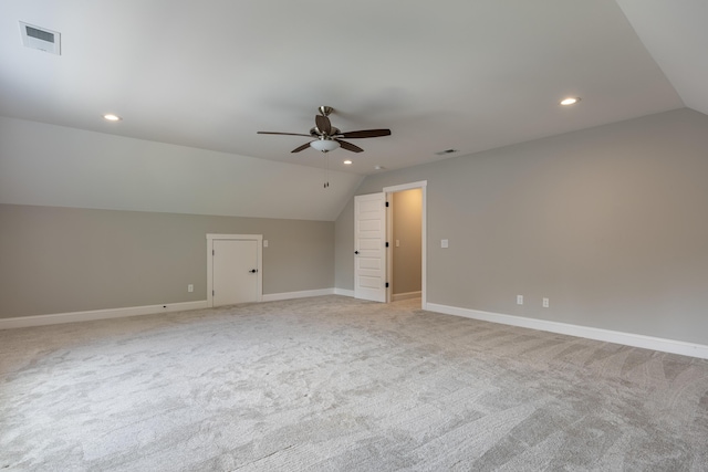 additional living space featuring ceiling fan, light carpet, and lofted ceiling