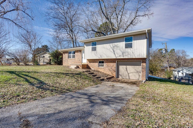 tri-level home with a garage and a front yard