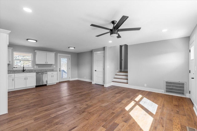 unfurnished living room featuring ceiling fan, dark hardwood / wood-style floors, and sink