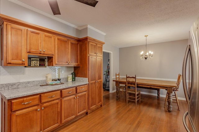 kitchen featuring brown cabinetry and light wood finished floors