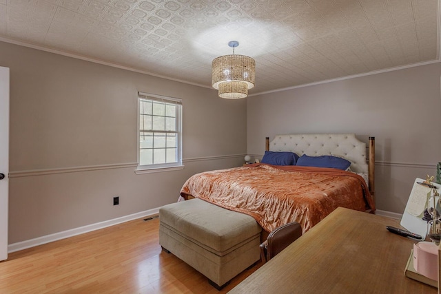 bedroom with a chandelier, baseboards, wood finished floors, and ornamental molding