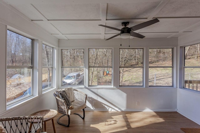 sunroom / solarium featuring ceiling fan