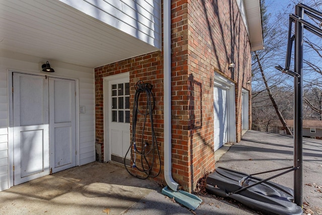 view of exterior entry featuring brick siding