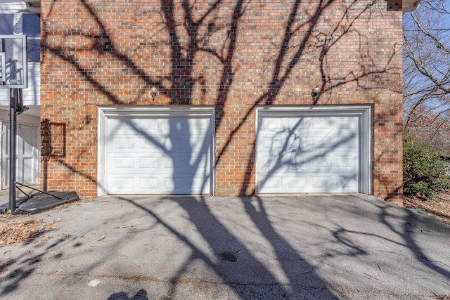 garage featuring concrete driveway