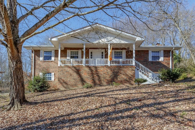 neoclassical home with brick siding and covered porch