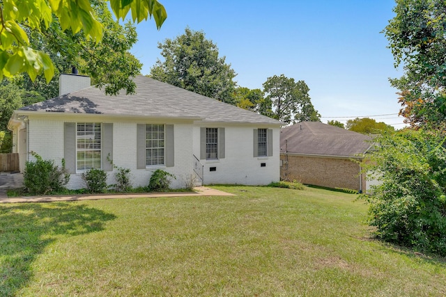 rear view of house with a lawn