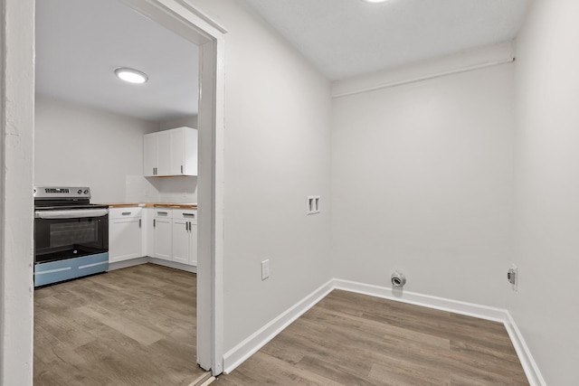 laundry area with light hardwood / wood-style floors