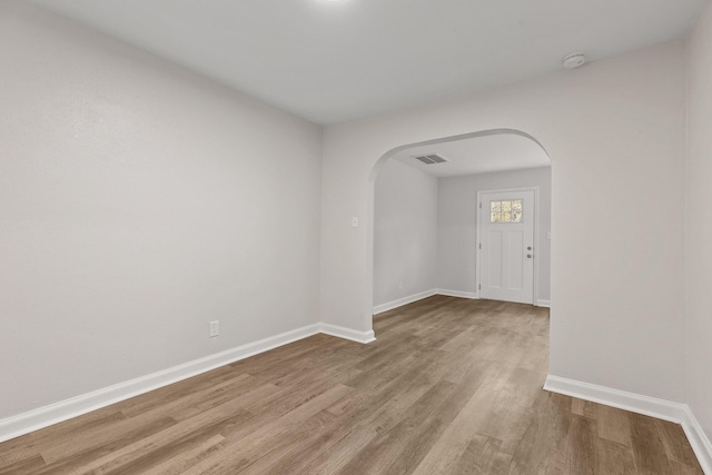 unfurnished room with light wood-type flooring